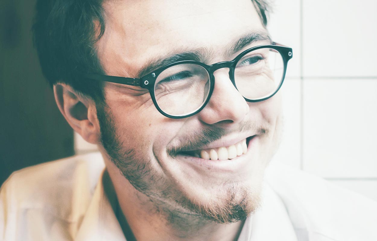 Smiling invisalign man with glasses